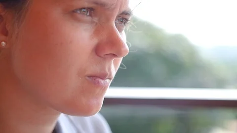 The harsh girl thought for a while that she was looking into the distance Stock Footage 90842164
