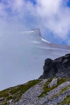 Harsh stoney mountain with cold cloud and fog cover 2 Stock Photos