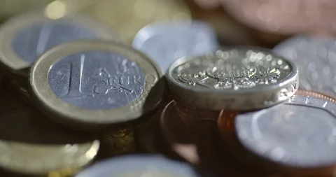 A harshly lit shot rotating around euros and pounds Stock Footage 88487843