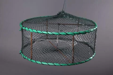 Harvest gear of fixed disk-type crab cages  with three entrance on grey backg Stock Photos