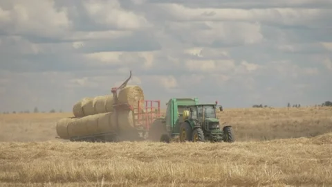Harvest hay and tractor in fields Stock Footage 141743940
