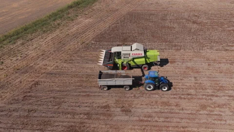 Harvest machines pausing on dry striped farmland, Rural Hungary Drone View Vídeos de archivo 346340276