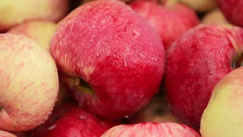Harvest many red ripe juicy apples close up background Stock Footage