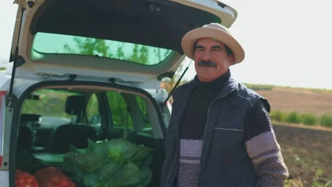 Harvest Reflections Elderly Worker in Thought Amidst Potato Sacks Stock Footage 273983456
