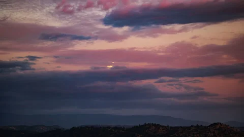 Harvest Super Moon Rises through Sunset Colored Clouds Stock Footage 285076089