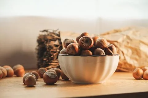 Harvested hazelnuts in a rustic kitchen setting enhance natural beauty Stock Photos