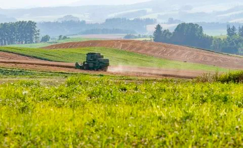 Harvester machine working in the field Stock Photos