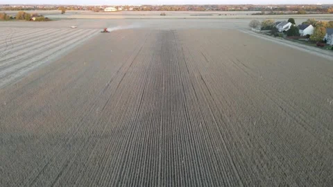 Harvester machine working in a field at sunset.Aerial drone shot of corn harvest Stock Footage 142151802