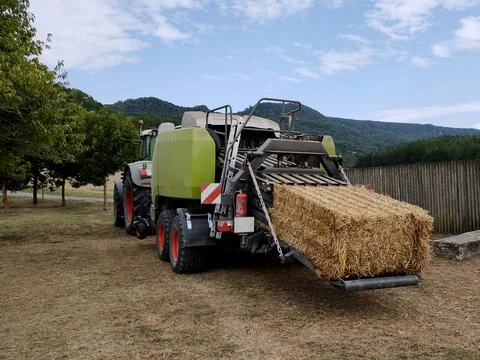 A harvester that pulls hay from the fields and turns it into briquettes Stock Photos