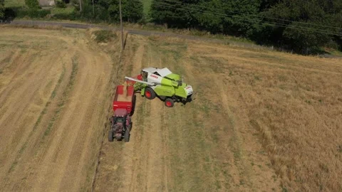 Harvester with a Tractor Stock Footage 144307077