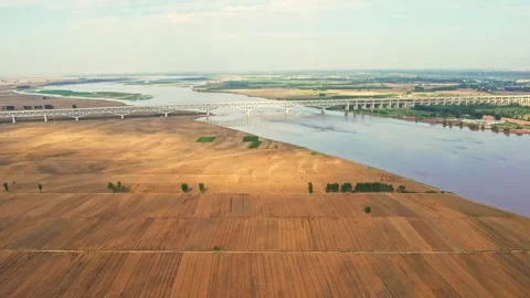Harvesting Of Wheat Fields By The Big River And Harvesting Of Autumn Crops. Stock Footage 288163505