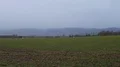 Harz mountain range foothills and skyline panning rainy weather pathway field 4k or 4k+ Resolution