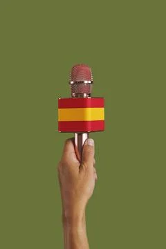 Has a microphone patterned with the spanish flag Stock Photos