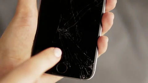 Has problems with a faulty mobile phone with a broken screen Stock-Footage 197323732