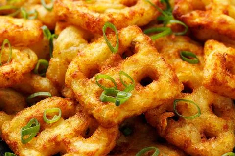 Hash Brown Waffles with Spring Onion on black plate Fotos Stock