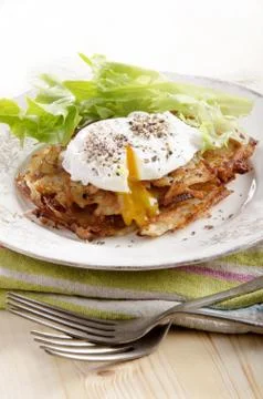 Hash browns with poached egg Stock Photos