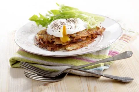 Hash browns with poached egg Stock Photos