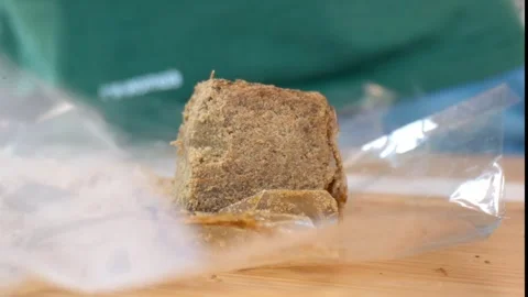 Hashish on a plastic bag fluttering in the wind, Macro shot, slow motion Stock Footage 325195170