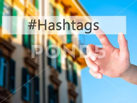 #Hashtags - Hand pressing a button on blurred background concept on visual sc Stock Photos