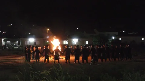 Hasidic Jews dancing in a circle around bonfire in the small village Meron Stock Footage 108529001