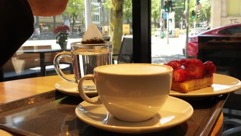 Hasing Coffee and Cake: The Perfect Café Afternoon Stockbeeldmateriaal 333474172