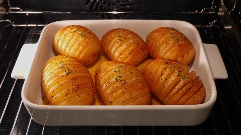 Hasselback potatoes with butter, process cooking baked in oven. Time lapse. Stock Footage 250263520