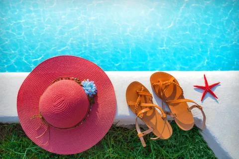 Hat and shoes by the pool Stock Photos