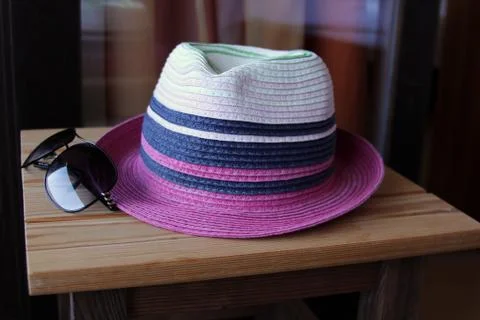 Hat and sunglasses on the table Stock Photos