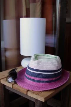 Hat and sunglasses on the table Stock Photos