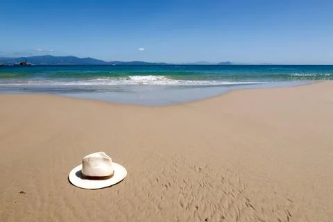 Hat on beach sand Stock Photos
