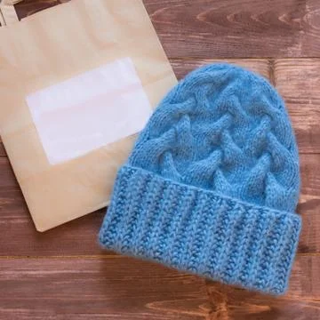 Hat of blue virgin wool hand-bound near a paper bag Stock Photos