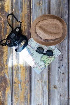A hat, a camera, a map, and sunglasses Stock Photos