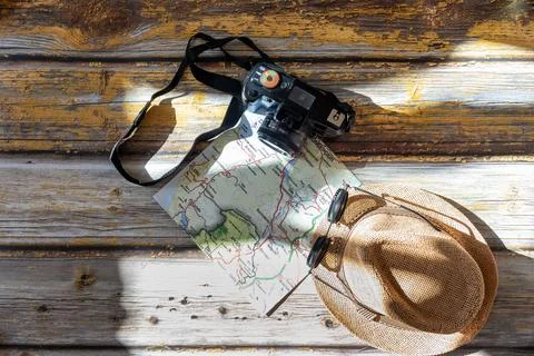 A hat, a camera, a map, and sunglasses Stock Photos