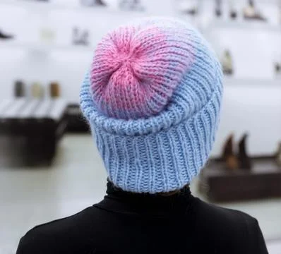 Hat with knitted Welt turned manually with a gradient of blue and pink wool Stock Photos