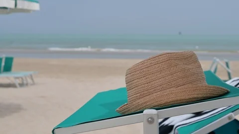 Hat on a lounger and beach Video stock 114580516