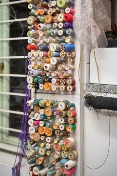 Hat maker workshop. Close up of colorful thread spools. Stock Photos