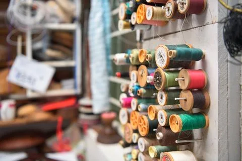 Hat maker workshop. Close up of colorful thread spools. Stock Photos