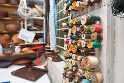Hat maker workshop. Close up of colorful thread spools. Stock Photos