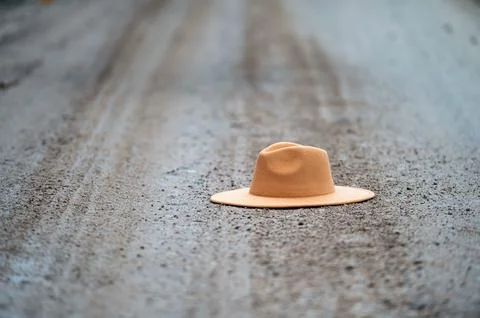 Hat on the road. Selective focus and shallow depth of field. Stock Photos