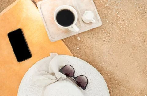 Hat on towel on the beach. Stock Photos