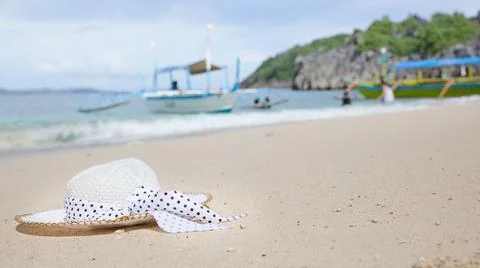 Hat on a white sandy beach. White sand. Sea traveling. Stock Photos