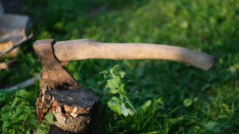 Hatchet in the stump at the country Stock Photos