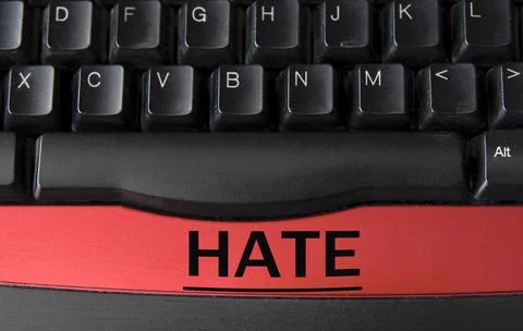 HATE - word on a white sheet against the background of a computer keyboard Stock Photos