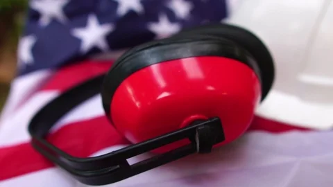 Hats and various labor protective equipment is placed on the flag of the United Stock Footage 106396008