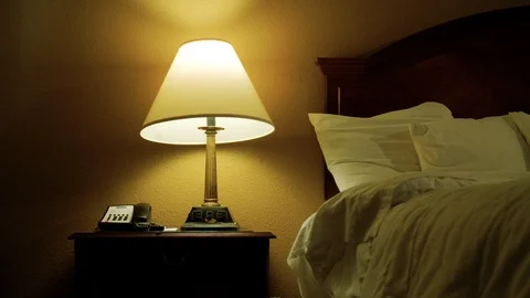 A haunted ghost lamp shade moves and rotates on its own in dim bedroom 스톡 동영상 113296670