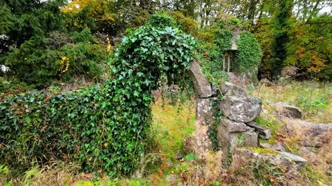 Haunted Ireland walking through an arched ruins doorway leading to an Stock Footage 288087446