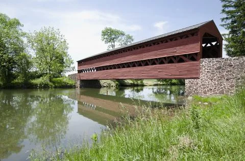 Haunted Sachs Covered Bridge over calm Marsh Creek Stock Photos