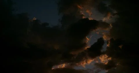 Haunting cloudscape in the western sky at the cusp of darkness. Stock Photos