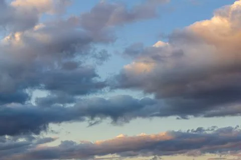 A haunting stormy sky. Cloudy clouds in the setting sun. A natural phenomenon Stock Photos