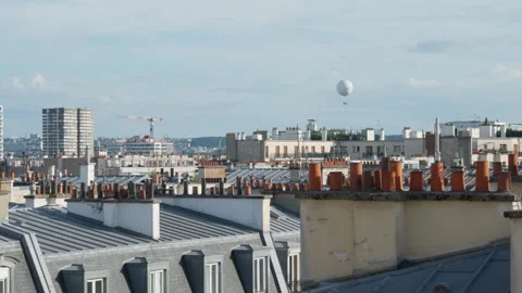 Haussmann buildings feature Parisian rooftops and an air balloon in Paris sky Stock Footage 337294346